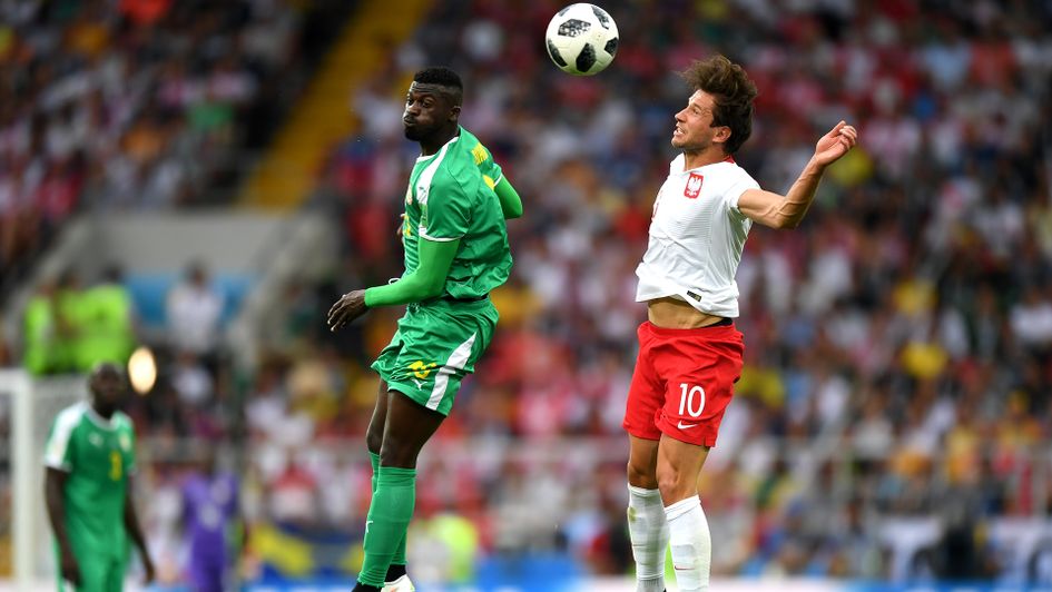 Poland and Senegal battle for the ball