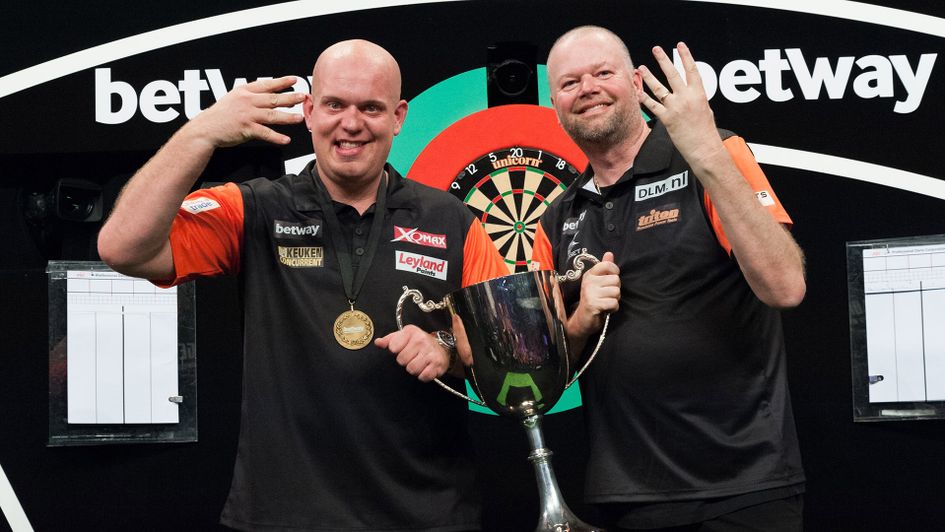 Raymond van Barneveld and Michael van Gerwen hold the World Cup of Darts trophy (Picture: Kelly Deckers/PDC)