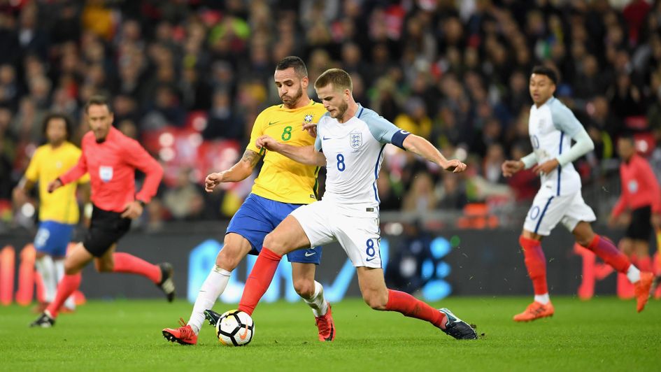 Renato Augusto and Eric Dier compete for the ball
