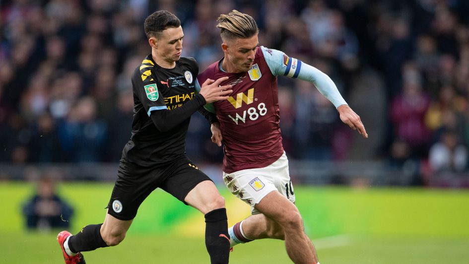 Phil Foden and Jack Grealish battle for the ball