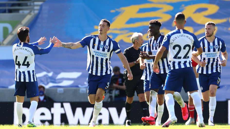 Lewis Dunk: Brighton defender celebrates a scrappy equaliser against Arsenal
