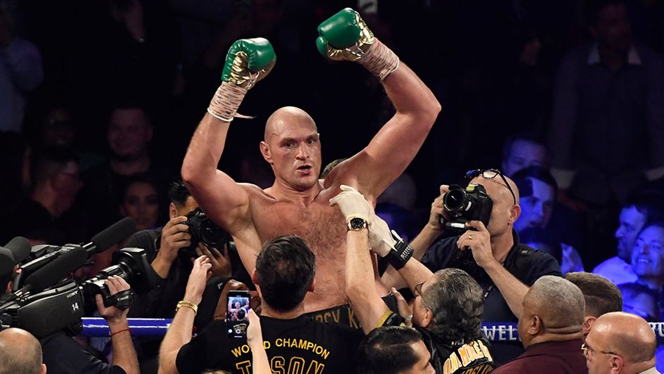 Tyson Fury celebrates beating Deontay Wilder